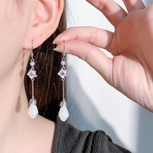 Vintage long tassel earrings featuring magnolia flower motifs and white teardrop stones