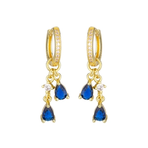 Detail of gold huggie earrings with pave zircons and blue pear-shaped sapphire drops