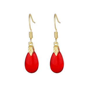 Detail of elegant gold drop earrings with red carnelian-style waterdrop pendants