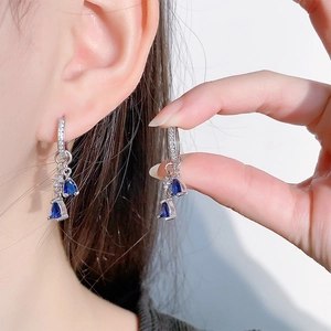 Elegant silver earrings with pear-shaped blue sapphire droplets and sparkling zircons