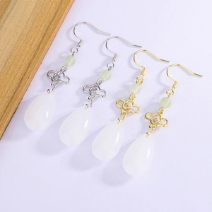 Detail of Chinese cloud earrings with green beads and white waterdrop pendants