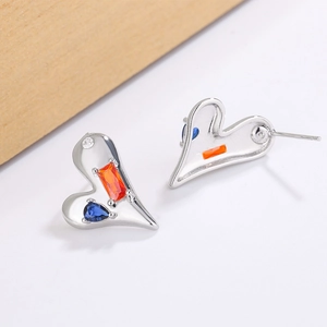 Asymmetric heart earrings with blue and orange cubic zirconia in polished silver metal