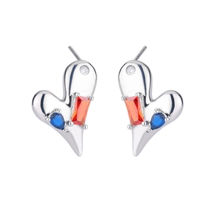 Detail view of asymmetric heart-shaped silver earrings with colorful zircon stones