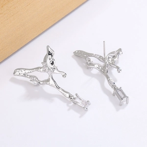 Detail of liquid metal butterfly earrings featuring dangling rectangular cubic zirconia