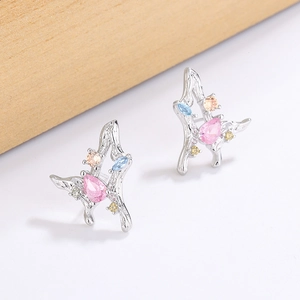 Detail of silver butterfly stud earrings with colorful zircon stones and pink drop gem