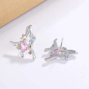 Detail view of butterfly studs with pink pear-shaped stone and colorful cubic zirconia