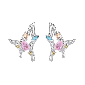 Close-up of butterfly earrings with colorful zircons and pink pear-shaped gemstone
