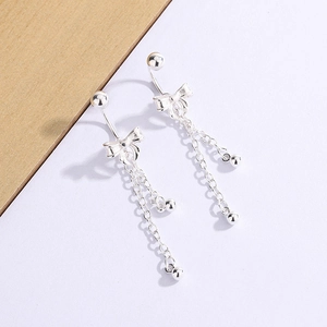 Detailed view of silver butterfly tassel earrings with dual hanging chain accents