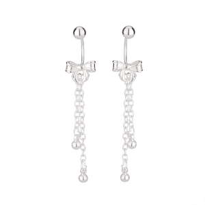 Detail showing polished silver butterfly tassel earrings with delicate hanging chains