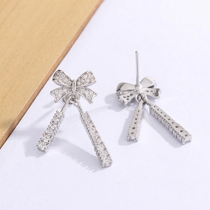 Sparkling silver bow knot tassel earrings with micro-set zircon and dangling fringes