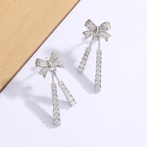 Silver bow tassel earrings with micro-set zircon crystals and long dangling chains