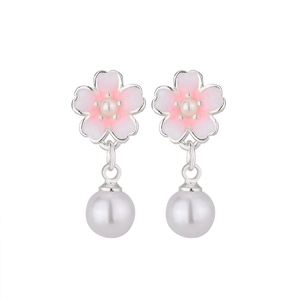 Detailed close-up of pink cherry blossom earrings with white pearls and enamel finish