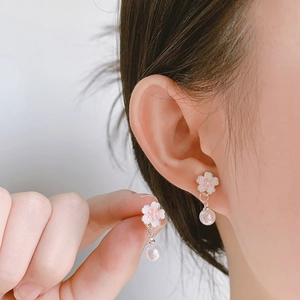 Pink cherry blossom earrings with pearl drop pendant shown on model and in hand