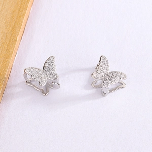 Detailed close-up of butterfly zircon earrings with silver finish and sparkling stones