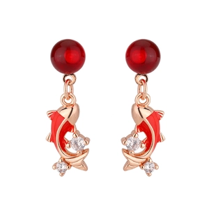 Detail of red koi fish earrings with sparkling zircon stones and rose gold finish