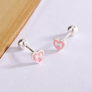 Detail of pink enamel heart earrings with S990 silver stamp and bow ornament