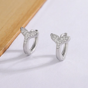 Detailed macro view of fishtail earrings set with white cubic zirconia crystals