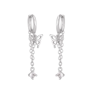 Close-up of silver butterfly earrings with long chains and sparkling cubic zirconia stones