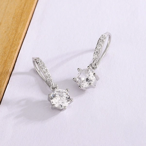 Elegant six-prong moissanite drop earrings with silver finish and shimmering accents
