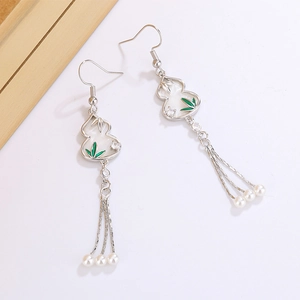 Detail of silver gourd earrings with bamboo leaves and pearl tassels in New Chinese style