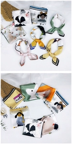 Detail of silk-like square scarf featuring hand-drawn illustrations and vibrant colors