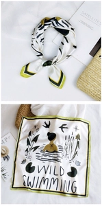 Detail of silk square scarf with zebra stripes and wild swimming illustration print