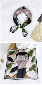 Close-up of artistic silk square scarf with portrait illustration and leafy patterns
