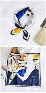 Detail of floral silk square scarf with navy and yellow botanical prints and props
