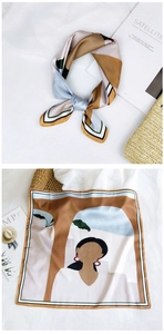 Detailed view of square silk scarf featuring abstract portrait and architectural prints