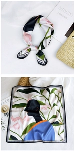 Detail of artistic print silk square scarf with floral silhouette and striped border