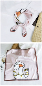 Detail of square silk scarf with funny cartoon duck print and colorful striped borders