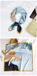 Detail of light blue silk-like square scarf with yellow border and palm leaf print