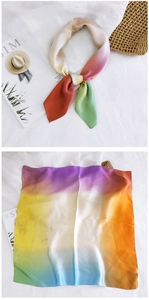 Detailed macro view of a colorful gradient square silk scarf with soft smooth texture