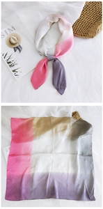 Macro shot of gradient silk scarf showing soft fabric texture and elegant color transition