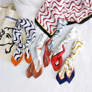 Detailed view of colorful zigzag pattern silk scarves with smooth glossy texture and finish