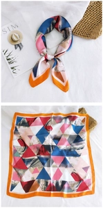 Detail of square silk scarf with colorful geometric triangles and elegant styling