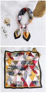 Detailed flat lay of geometric multicolor square silk scarf with artistic triangle patterns