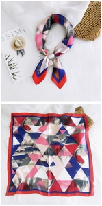 Detailed flat lay of gradient square silk scarf with geometric red and blue prints