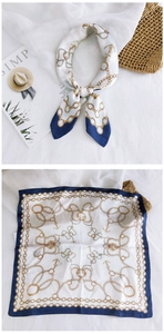 Close-up of nautical square scarf with navy borders and golden anchor patterns