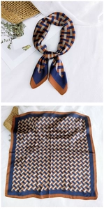 Macro detail of geometric woven pattern and silky texture on a square fashion neckerchief