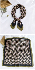 Detail view of square silk scarf with geometric weave pattern in black and olive green