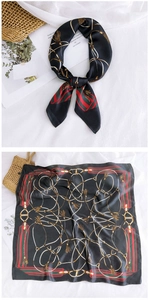 Detail of a square silk scarf with gold chain print and classic red-green stripes