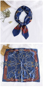 Detail view of navy silk square scarf with vintage golden chain and horsebit print