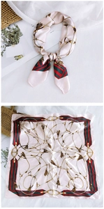 Detailed flat lay of a 70cm silk scarf with chain print and green-red stripe accents
