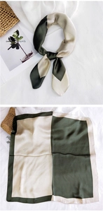 Detail of silk square scarf with olive green and beige color-block pattern