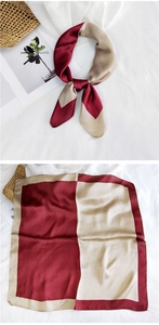 Detail of silk satin square scarf with burgundy and gold color block pattern