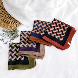 Silk-satin square scarves featuring geometric patterns in four elegant color palettes