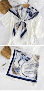 Detail of nautical print square scarf featuring navy sailboats and golden anchor patterns