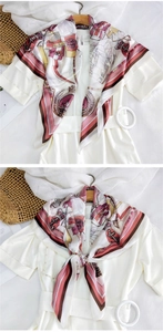 Detail of nautical print silk scarf featuring anchors and shields on a white dress