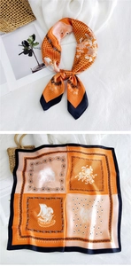Detailed pattern of orange and black square silk scarf featuring retro elephant prints